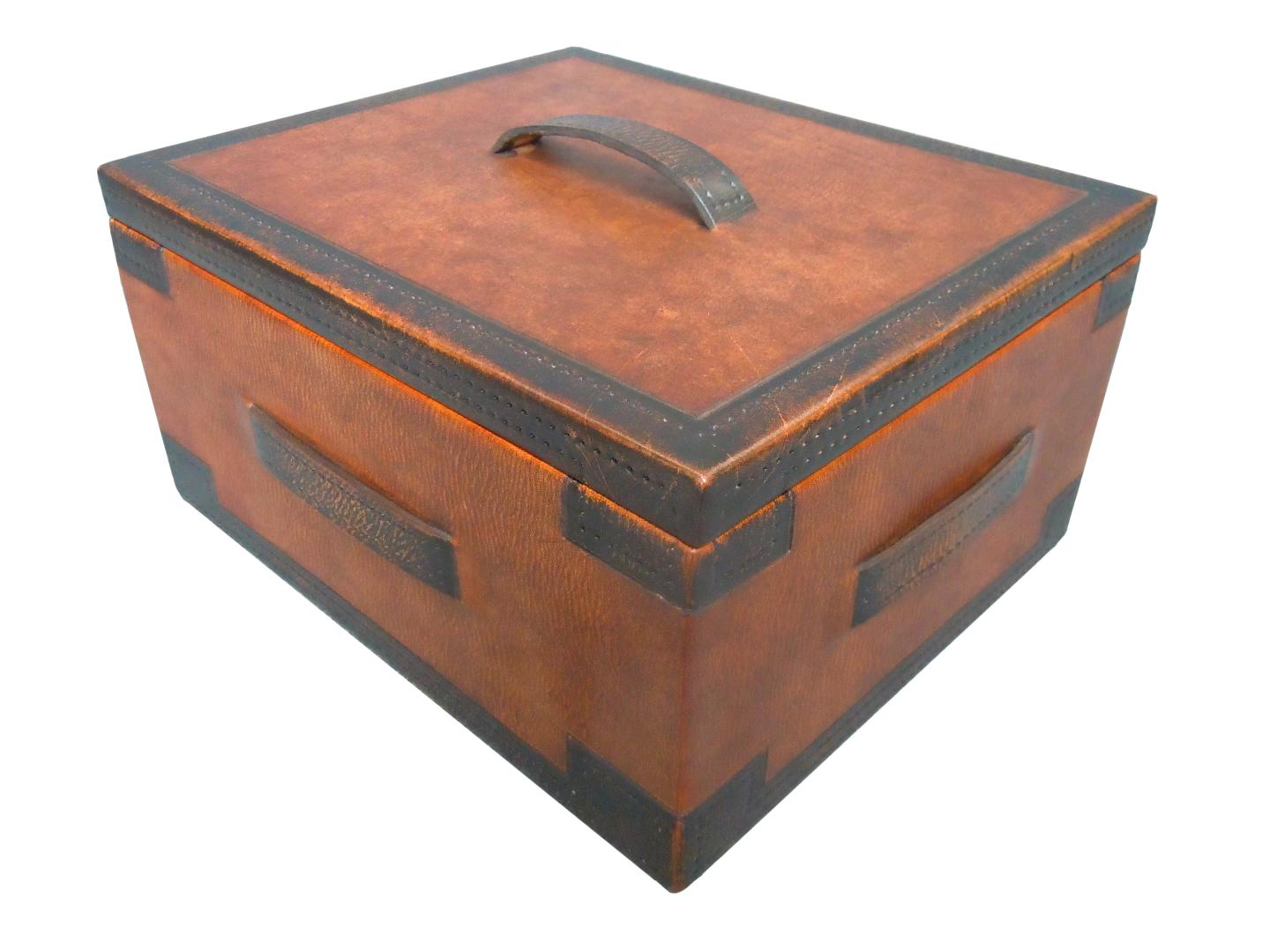 leather box with belts on the sides and top of the box